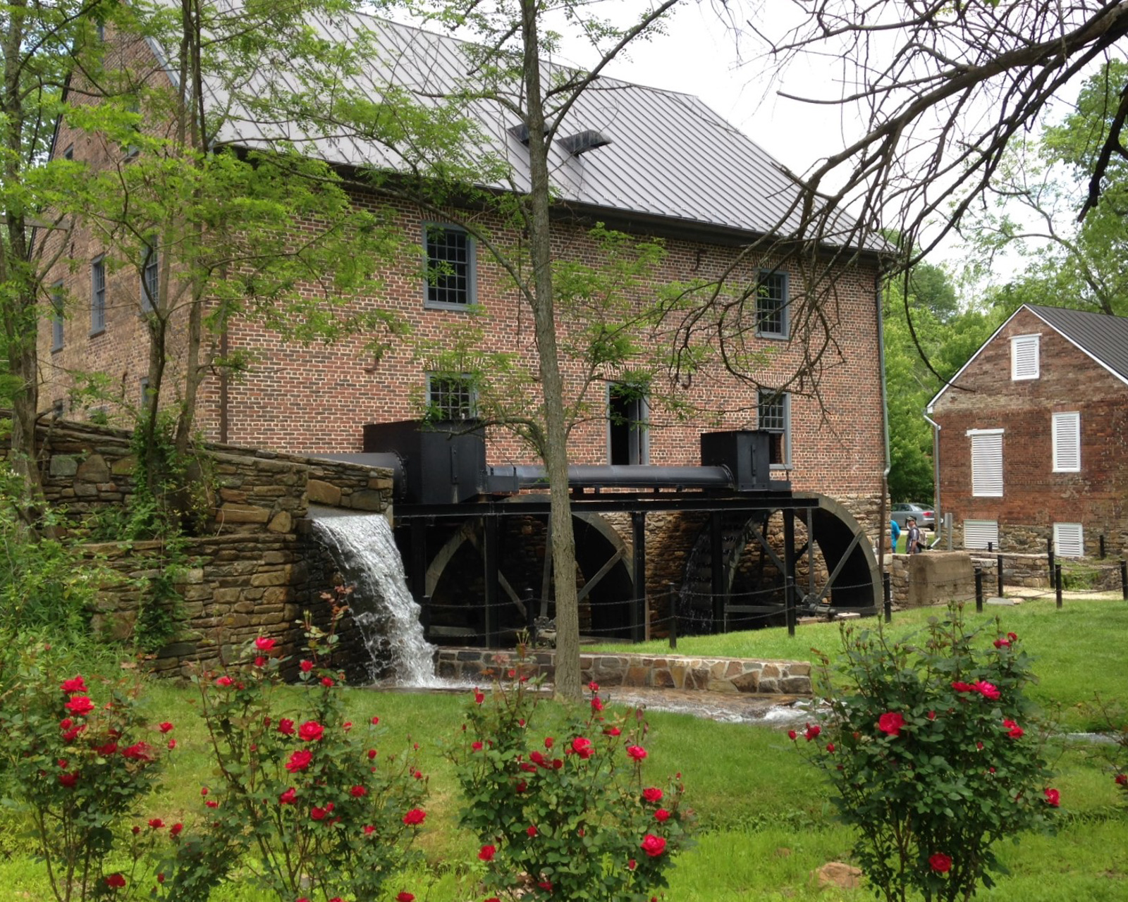 aldie mill historic area with its twin water wheels along side the historic brick building
