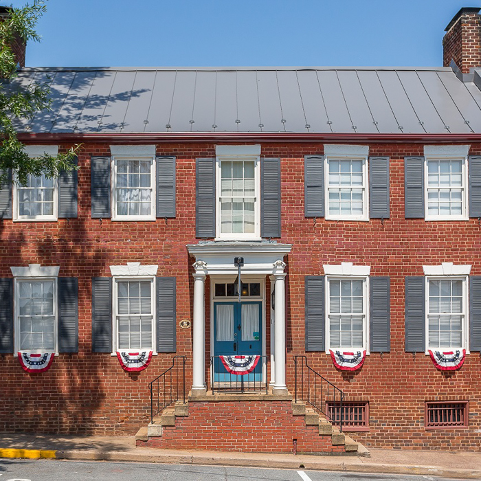 Holladay house with blue shutters and brick
