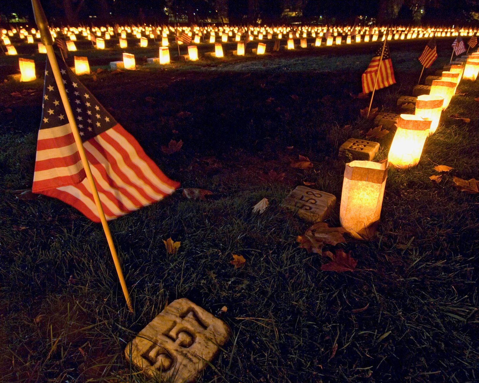 flags and candles placed at civil war era soldiers' graves